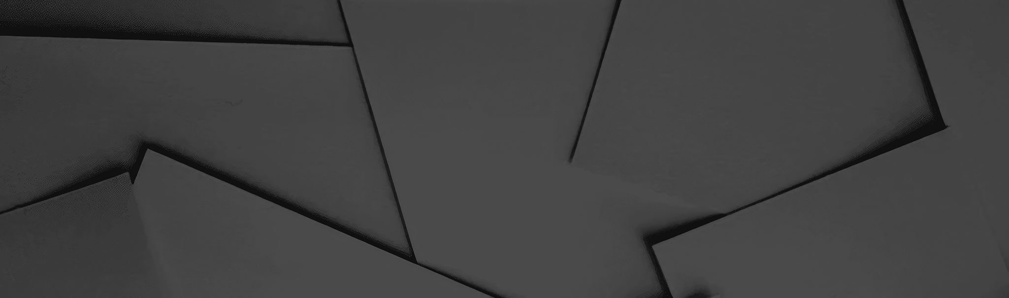 Dark grey abstract background with geometric folds and subtle textures, creating a modern, minimalist pattern.